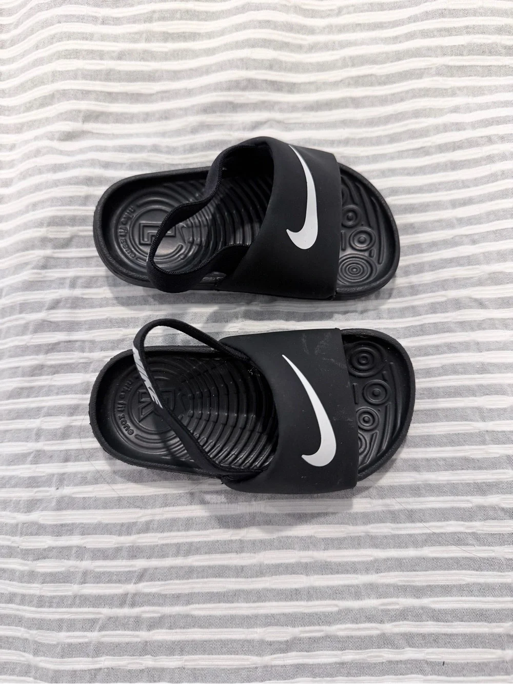 Nike Kids Black Slide Sandals with White Swoosh Logo
